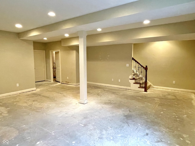 finished below grade area with stairway, recessed lighting, and baseboards