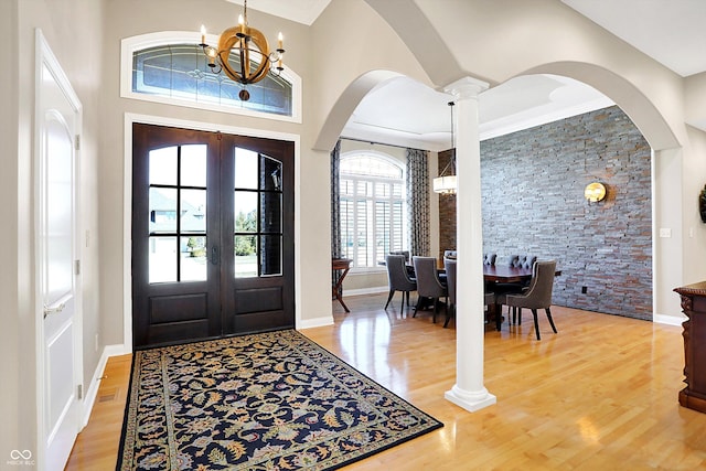 2110 Cheviot Ct, Greenwood, IN 46143 - entryway with light wood-style flooring, arched walkways, a chandelier, ornate columns, and french doors