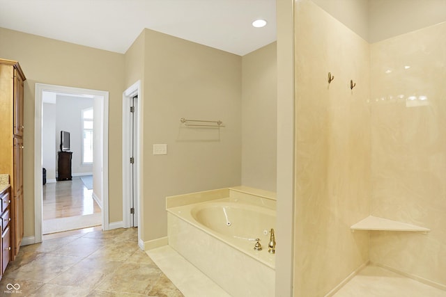 2110 Cheviot Ct, Greenwood, IN 46143 - full bathroom featuring a garden tub, baseboards, and vanity