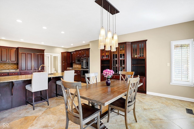 2110 Cheviot Ct, Greenwood, IN 46143 - dining area with a chandelier, recessed lighting, and baseboards