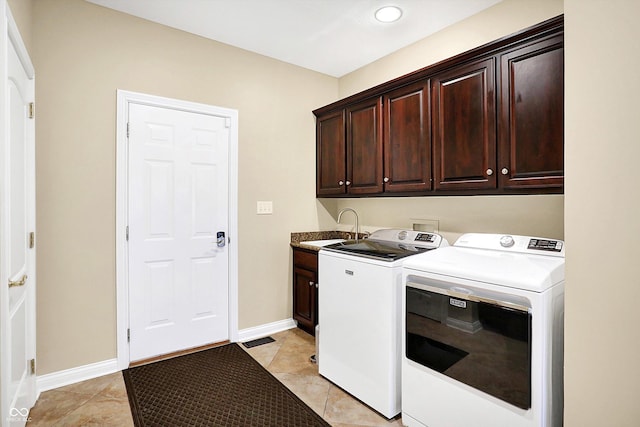 2110 Cheviot Ct, Greenwood, IN 46143 - laundry room featuring cabinet space, separate washer and dryer, recessed lighting, light tile patterned flooring, and baseboards