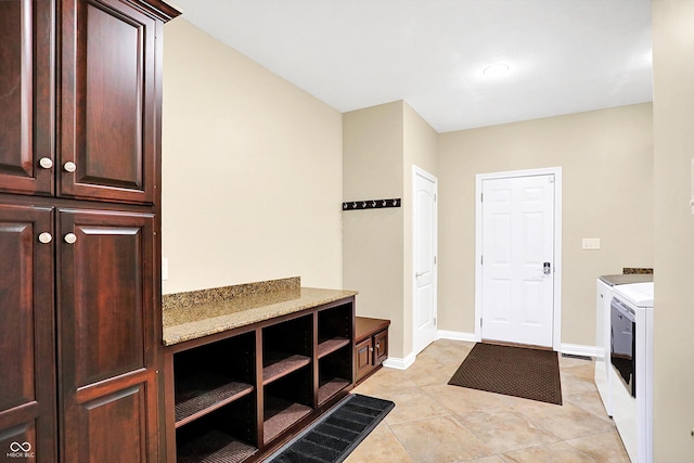 2110 Cheviot Ct, Greenwood, IN 46143 - mudroom featuring independent washer and dryer, light tile patterned floors, and baseboards