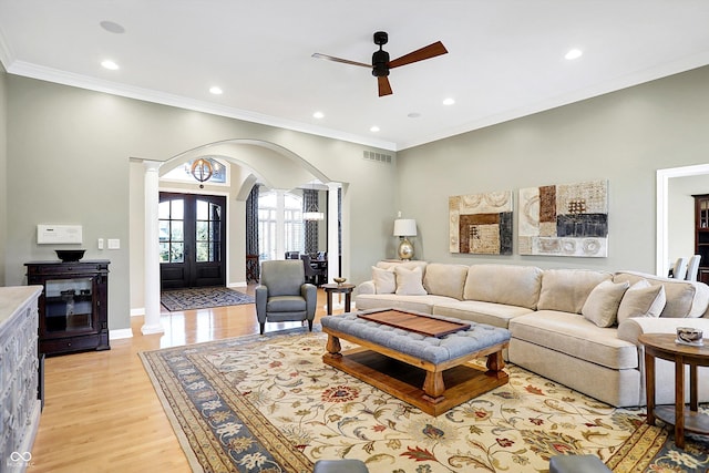 2110 Cheviot Ct, Greenwood, IN 46143 - living area with arched walkways, ceiling fan, recessed lighting, crown molding, and light wood-style flooring