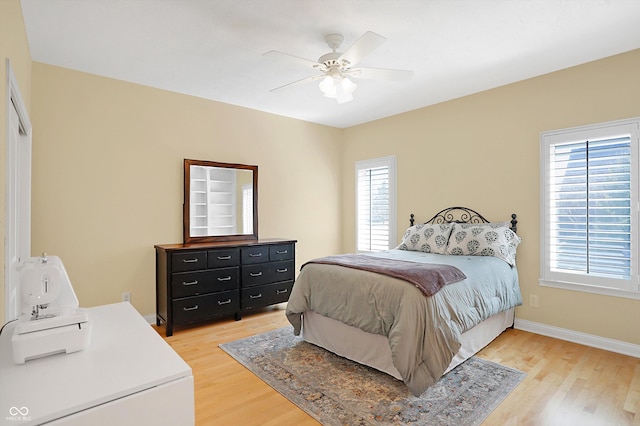 2110 Cheviot Ct, Greenwood, IN 46143 - bedroom featuring multiple windows, light wood-type flooring, baseboards, and a ceiling fan