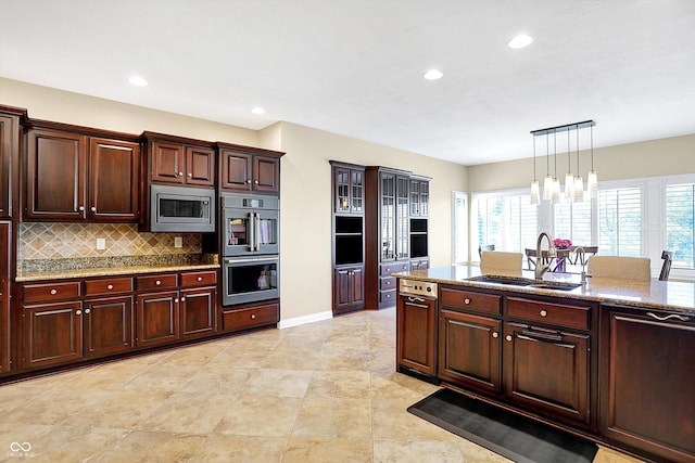 2110 Cheviot Ct, Greenwood, IN 46143 - kitchen with stainless steel appliances, a sink, backsplash, plenty of natural light, and recessed lighting