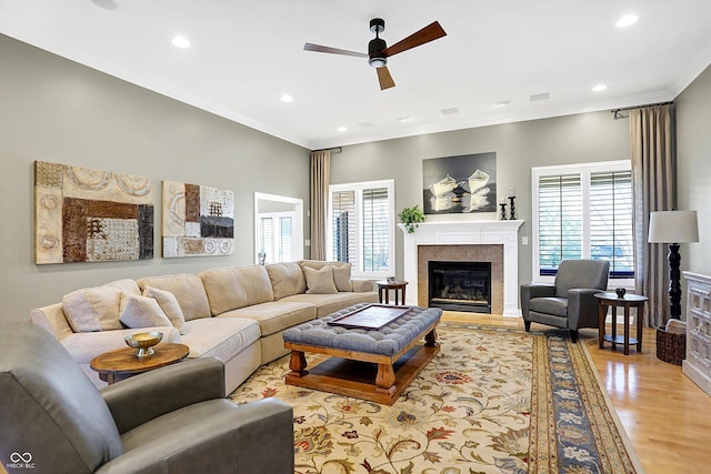 2110 Cheviot Ct, Greenwood, IN 46143 - living area with a fireplace, ceiling fan, healthy amount of natural light, light wood-style floors, and ornamental molding