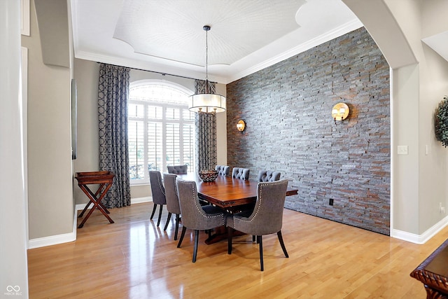 2110 Cheviot Ct, Greenwood, IN 46143 - dining room with light wood-type flooring, arched walkways, baseboards, a chandelier, and crown molding