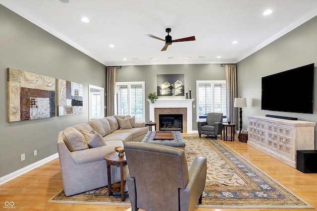 2110 Cheviot Ct, Greenwood, IN 46143 - living room with plenty of natural light, ceiling fan, crown molding, a glass covered fireplace, and wood finished floors