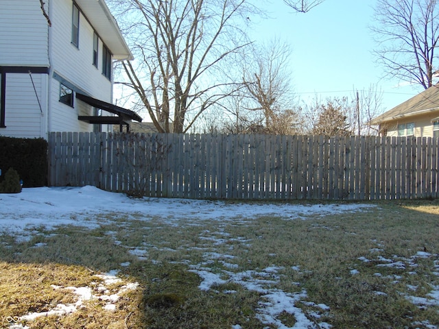 yard layered in snow with fence