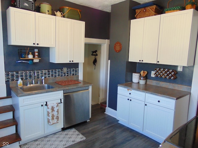 kitchen with white cabinetry, a sink, and stainless steel dishwasher