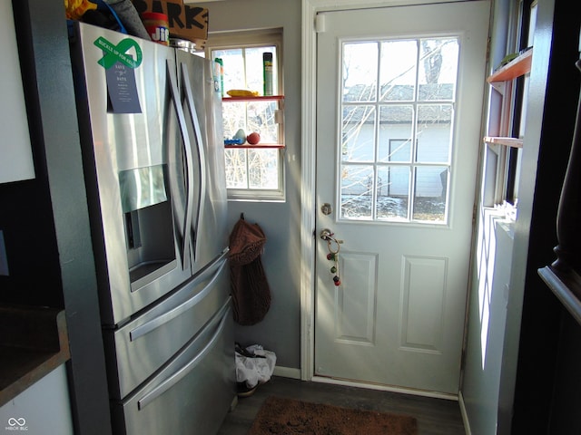 entryway featuring dark wood finished floors and baseboards