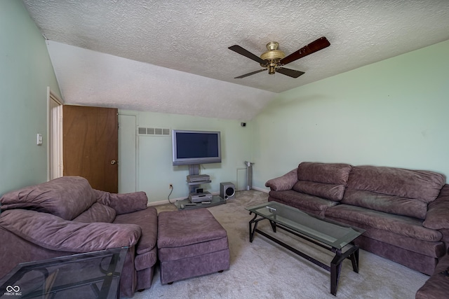 living room with visible vents, a ceiling fan, a textured ceiling, carpet, and vaulted ceiling