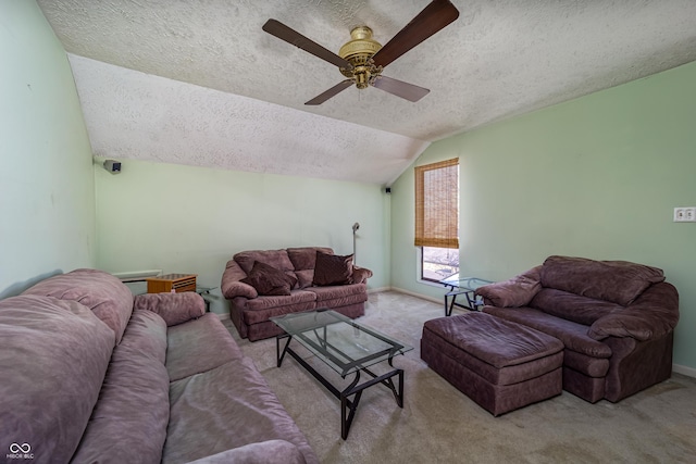 carpeted living area featuring baseboards, ceiling fan, a textured ceiling, and lofted ceiling