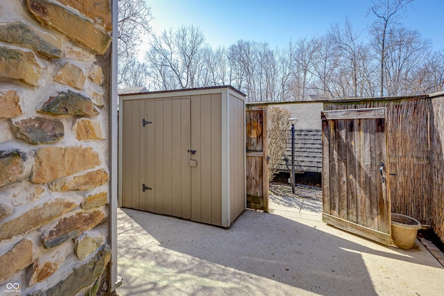 view of shed with fence