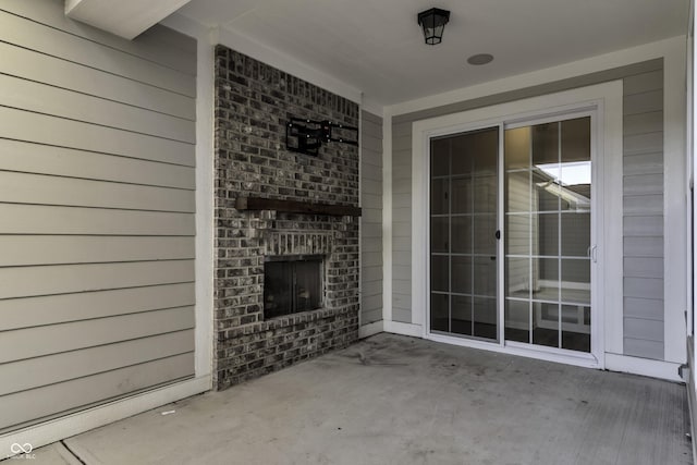 view of patio / terrace featuring an outdoor brick fireplace