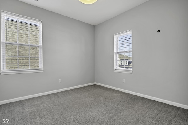 carpeted empty room with baseboards