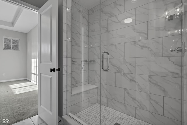 bathroom with baseboards and a stall shower