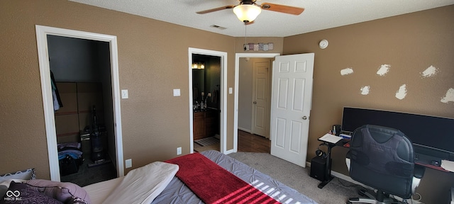 bedroom featuring ceiling fan, visible vents, and light colored carpet