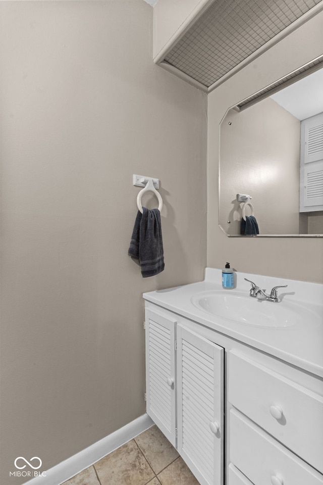 bathroom with vanity, baseboards, and tile patterned floors