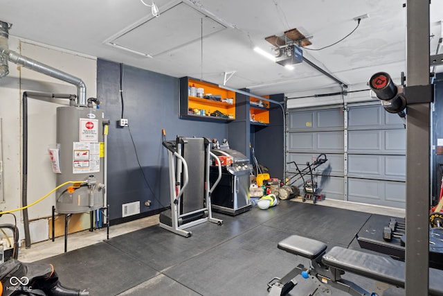 interior space with water heater, visible vents, attic access, and a garage