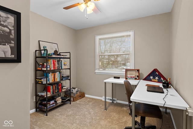 office space with light colored carpet, ceiling fan, visible vents, and baseboards