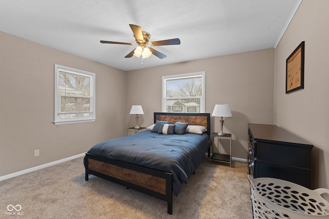 bedroom featuring light carpet, ceiling fan, baseboards, and a textured ceiling