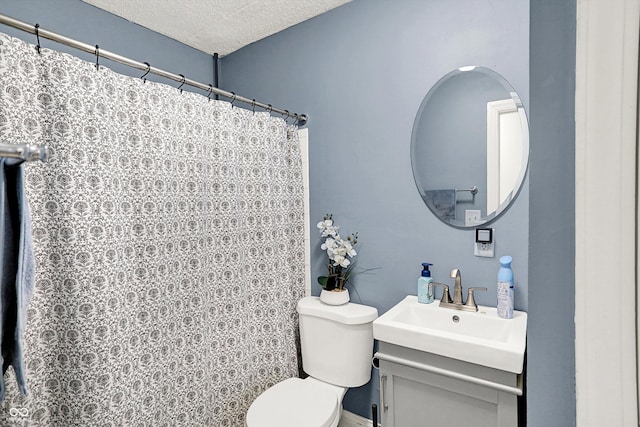 full bath featuring toilet, curtained shower, a textured ceiling, and vanity