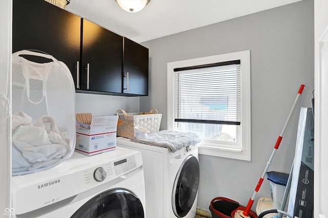 laundry area with cabinet space and washer and clothes dryer