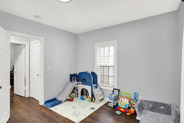 game room with dark wood finished floors