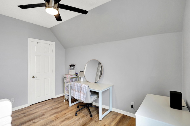 office area with vaulted ceiling, ceiling fan, baseboards, and light wood-style floors