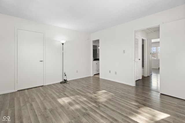 interior space with baseboards and wood finished floors