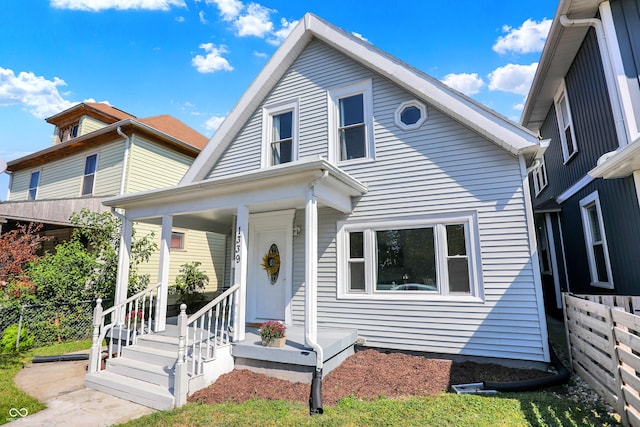 view of front facade featuring fence and a porch