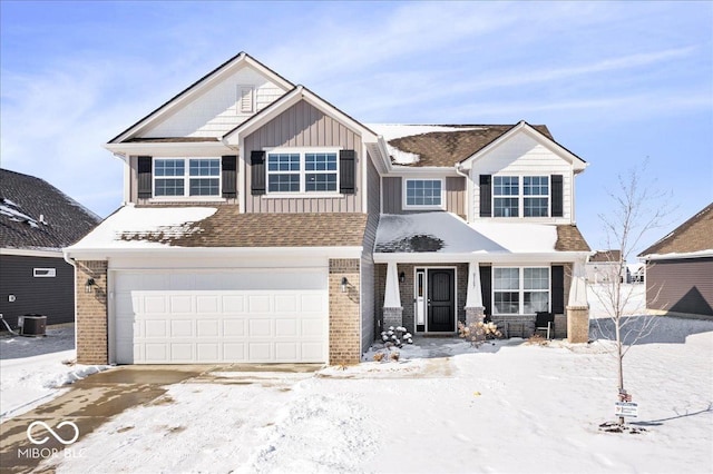 view of front of house featuring a garage, central AC unit, board and batten siding, and brick siding