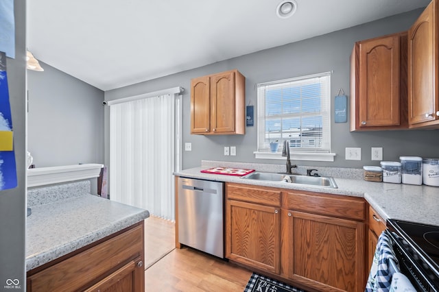 kitchen featuring a sink, light stone counters, stainless steel dishwasher, and range with electric stovetop