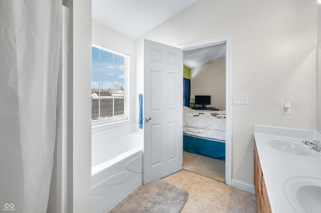 ensuite bathroom featuring double vanity, ensuite bathroom, vaulted ceiling, a sink, and tile patterned floors