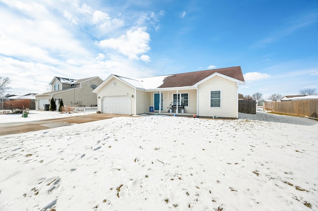 view of front of home with a garage and fence