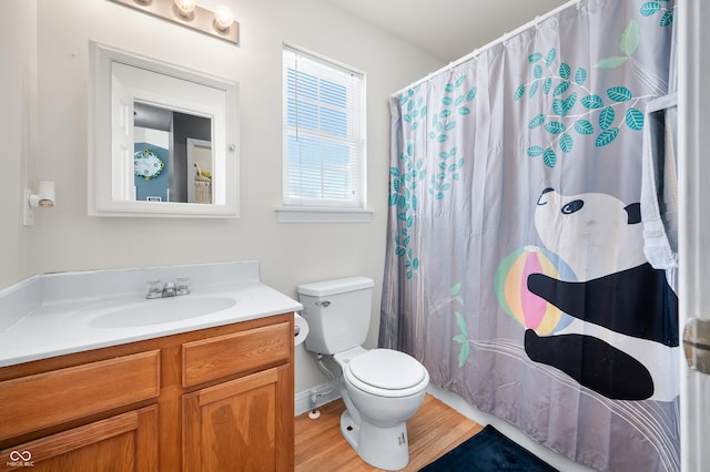 full bath featuring a shower with curtain, vanity, toilet, and wood finished floors