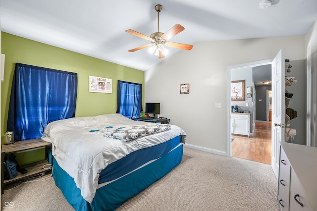 bedroom with vaulted ceiling, baseboards, a ceiling fan, and light colored carpet