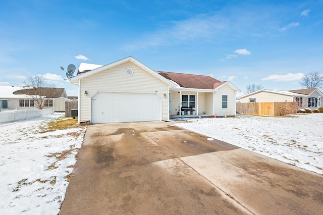 ranch-style house with a garage, a shed, fence, and concrete driveway