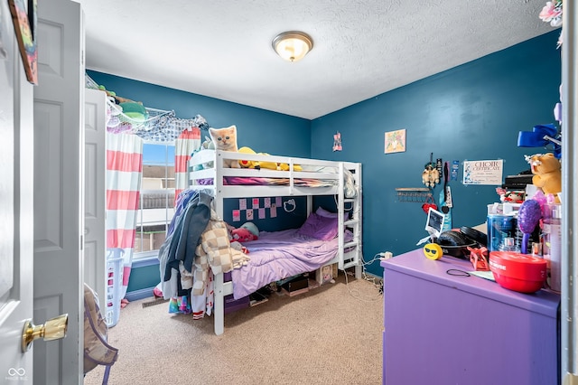 carpeted bedroom featuring a textured ceiling