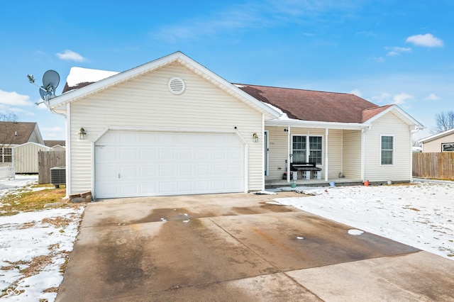 single story home featuring an attached garage, fence, a porch, and concrete driveway