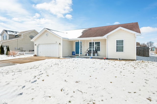 ranch-style house featuring an attached garage, fence, and a porch