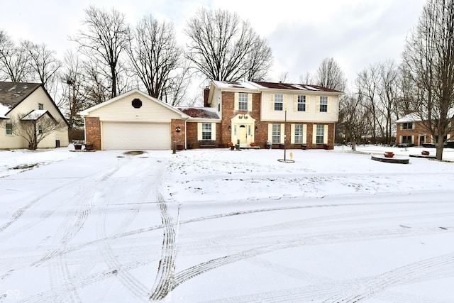 view of front facade with an attached garage and brick siding