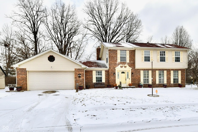 view of front of house featuring an attached garage and brick siding