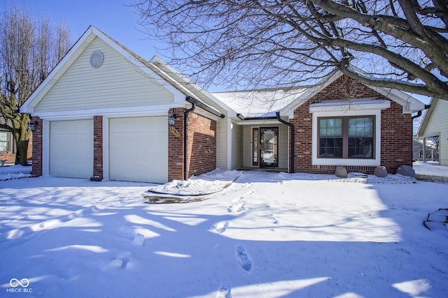 view of front facade featuring brick siding and an attached garage