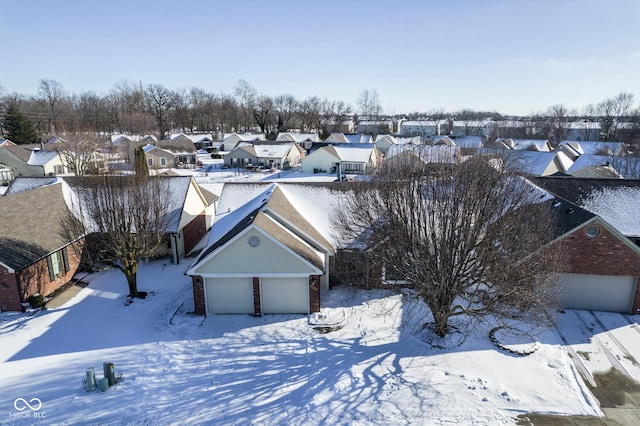 snowy aerial view featuring a residential view