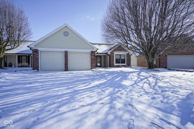 ranch-style home with an attached garage and brick siding