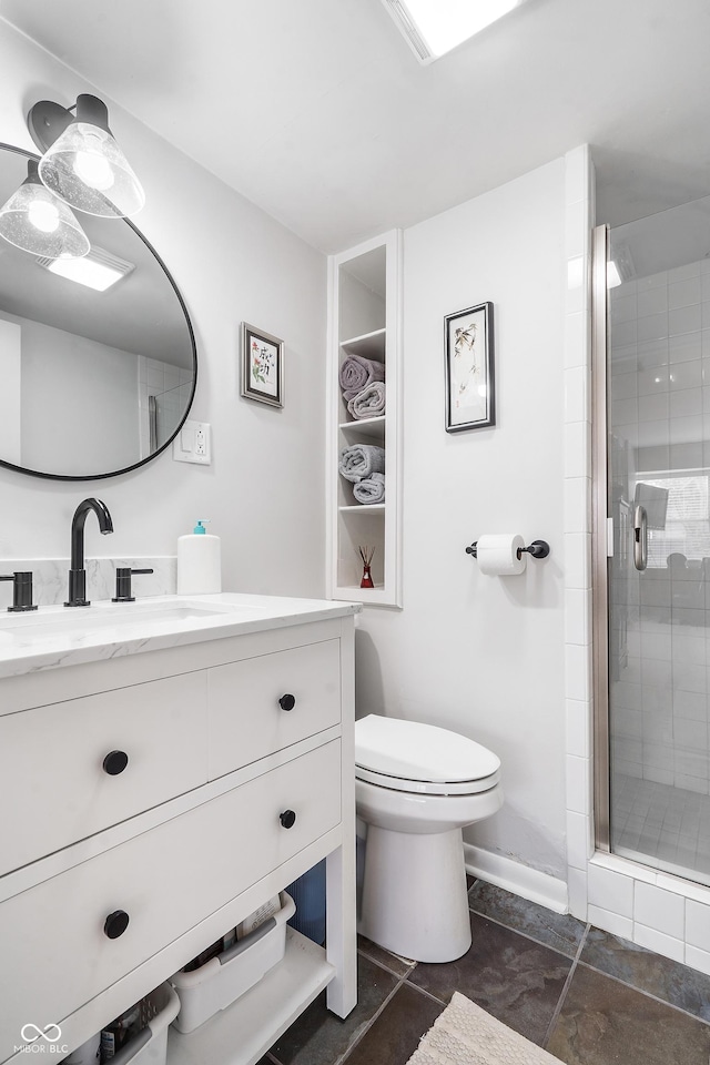 bathroom with toilet, vanity, and a shower stall