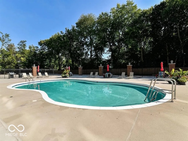 pool featuring a patio area and fence