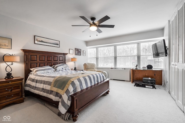 bedroom featuring a ceiling fan and light carpet